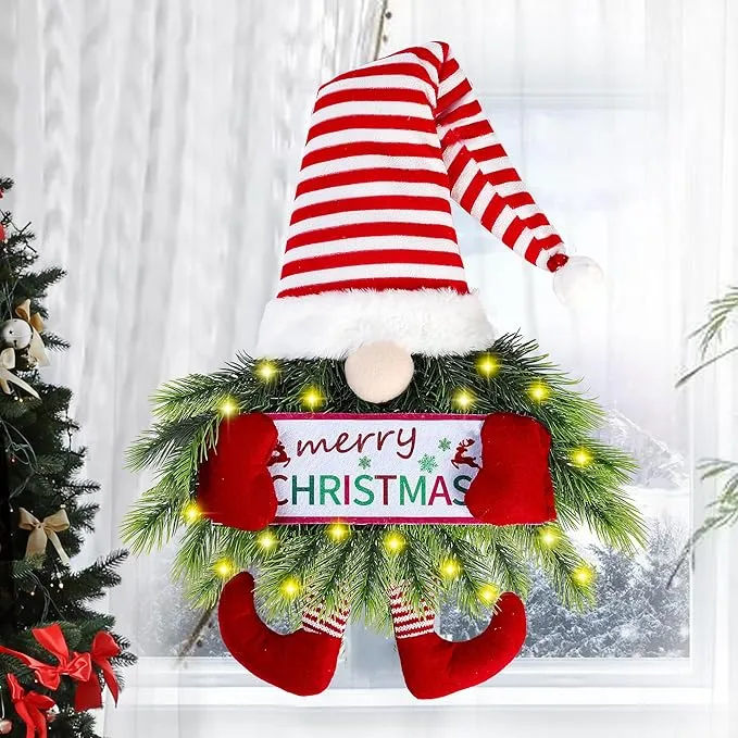 Christmas gnome wreath with red striped hat, LED fairy lights, evergreen branches, and a Merry Christmas sign.