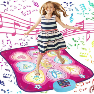 A young girl in a striped dress dancing on a pink heart-shaped electronic dance mat featuring a blue control console.